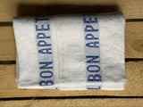 Charvet Éditions "Bon Appetit" (Blue), White woven linen tea towel. Made in France.