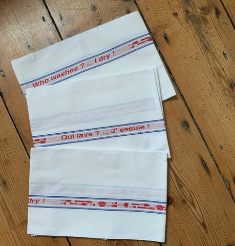 Charvet Éditions "Qui Lave? J’Essuie!", white woven cotton tea towel. Made in France. - Home Landing